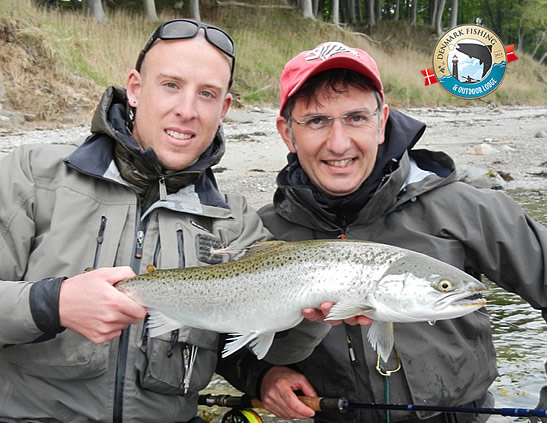 Sea trout fishing at our lodge. Omar Gade fishing guide holding a nice sea trout from Fyn